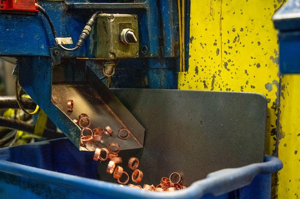 tube-fabricator-rebuilds-line-of-cutoff-machines-1677100814 Close-up of tube cutting process producing precise PEX crimp rings with clean, burr-free edges